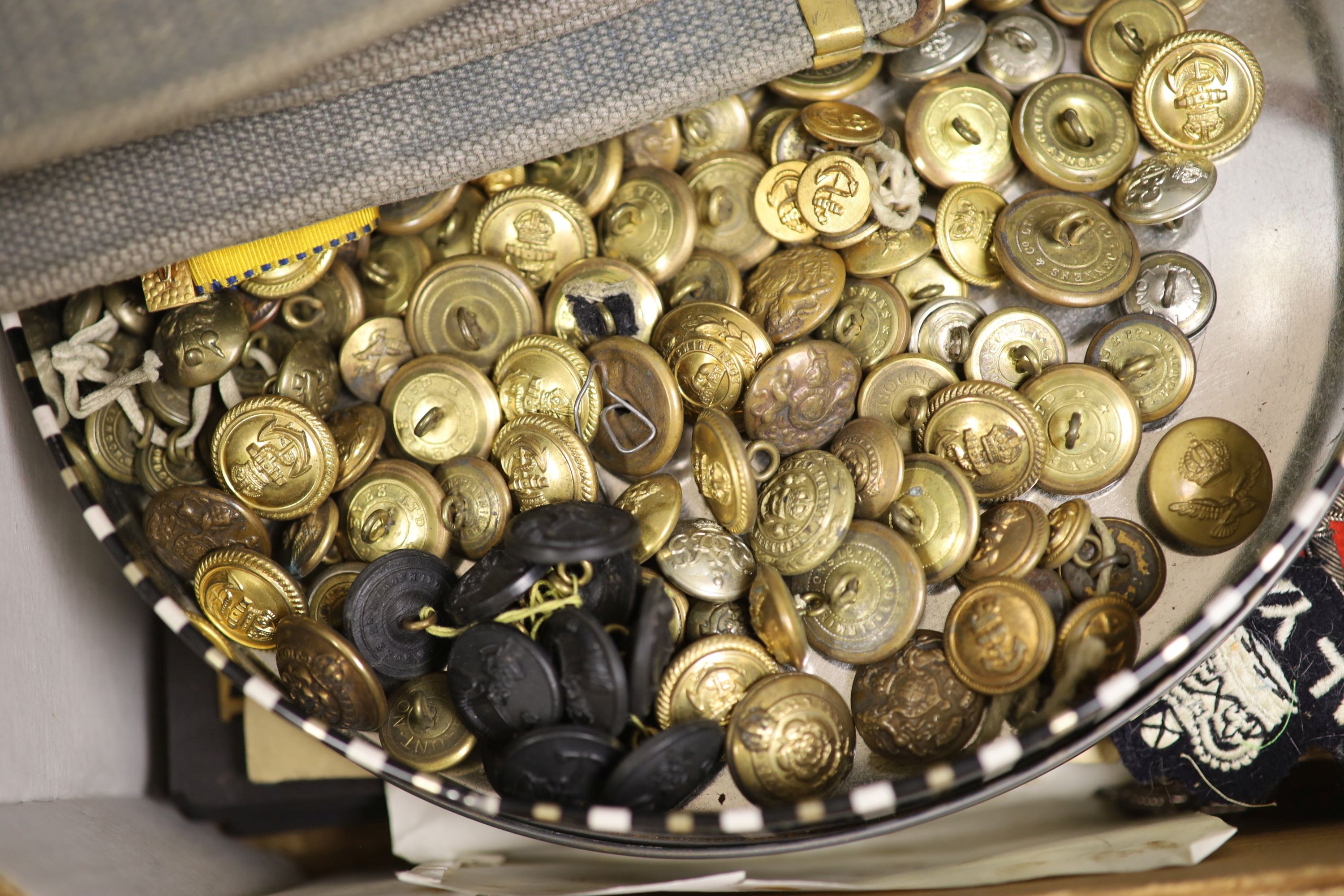 A group of British military cap badges and buttons, various commemorative medals and Pakistan General Service Medals